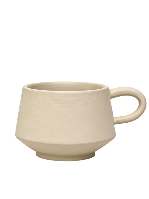 Unglazed handmade ceramic cup made from raw clay before firing