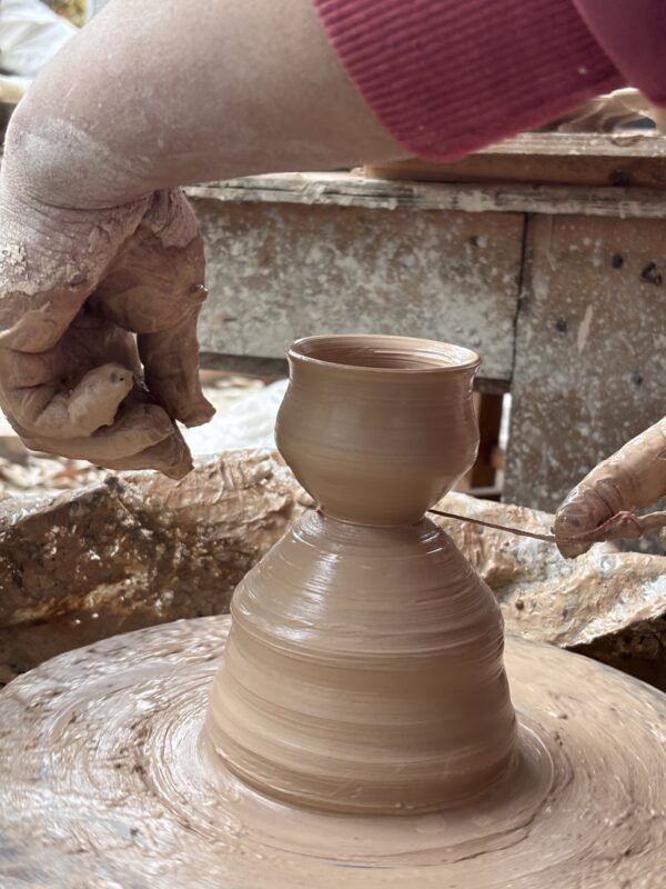 Traditional handmade pottery forming process before kiln firing