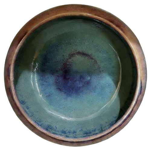 Top view of handmade ceramic bowl with natural kiln-fired glaze patterns