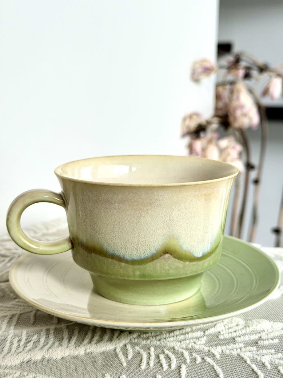 Artisan handmade ceramic coffee cup with green glaze in natural lifestyle setting, Yunnan pottery