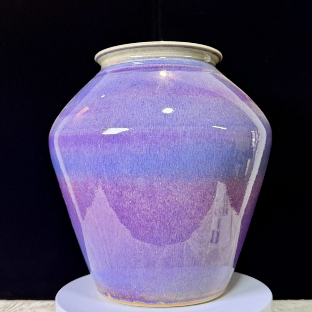 Front view of a handcrafted purple and blue gradient ceramic vase on a display stand, inspired by the Erhai Lake sunset in Yunnan.