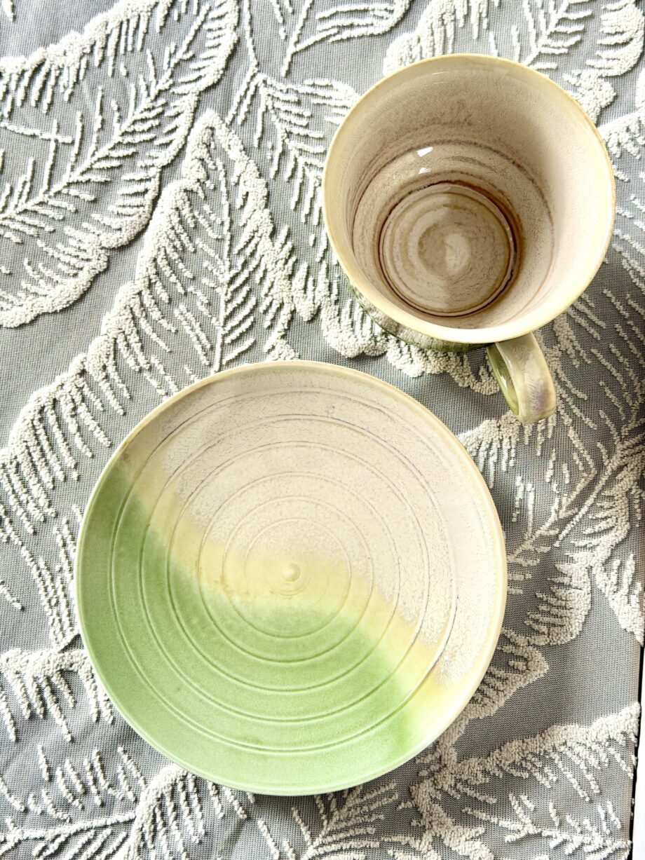 Top view of handmade ceramic coffee cup and saucer with natural green glaze from Yunnan China