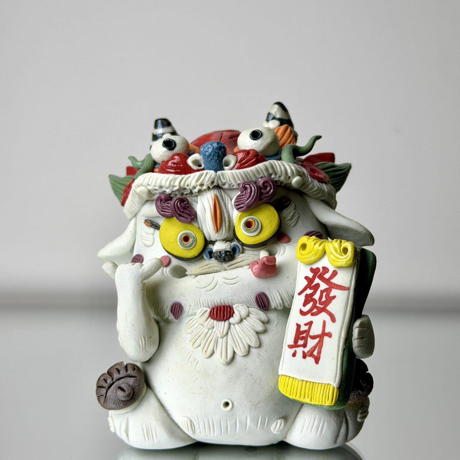 Side view of handmade qilin ceramic statue with colorful details and traditional Chinese design