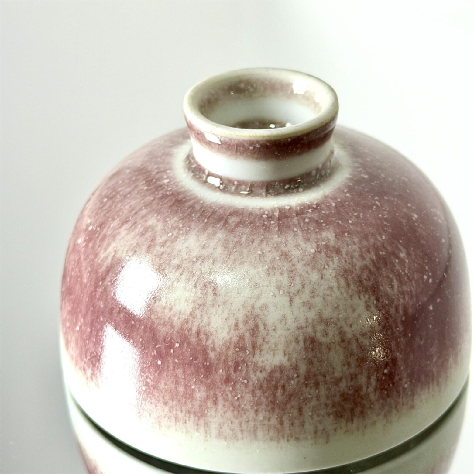 ceramic tea cup rim detail with natural glaze transition from white to red, high fired pottery